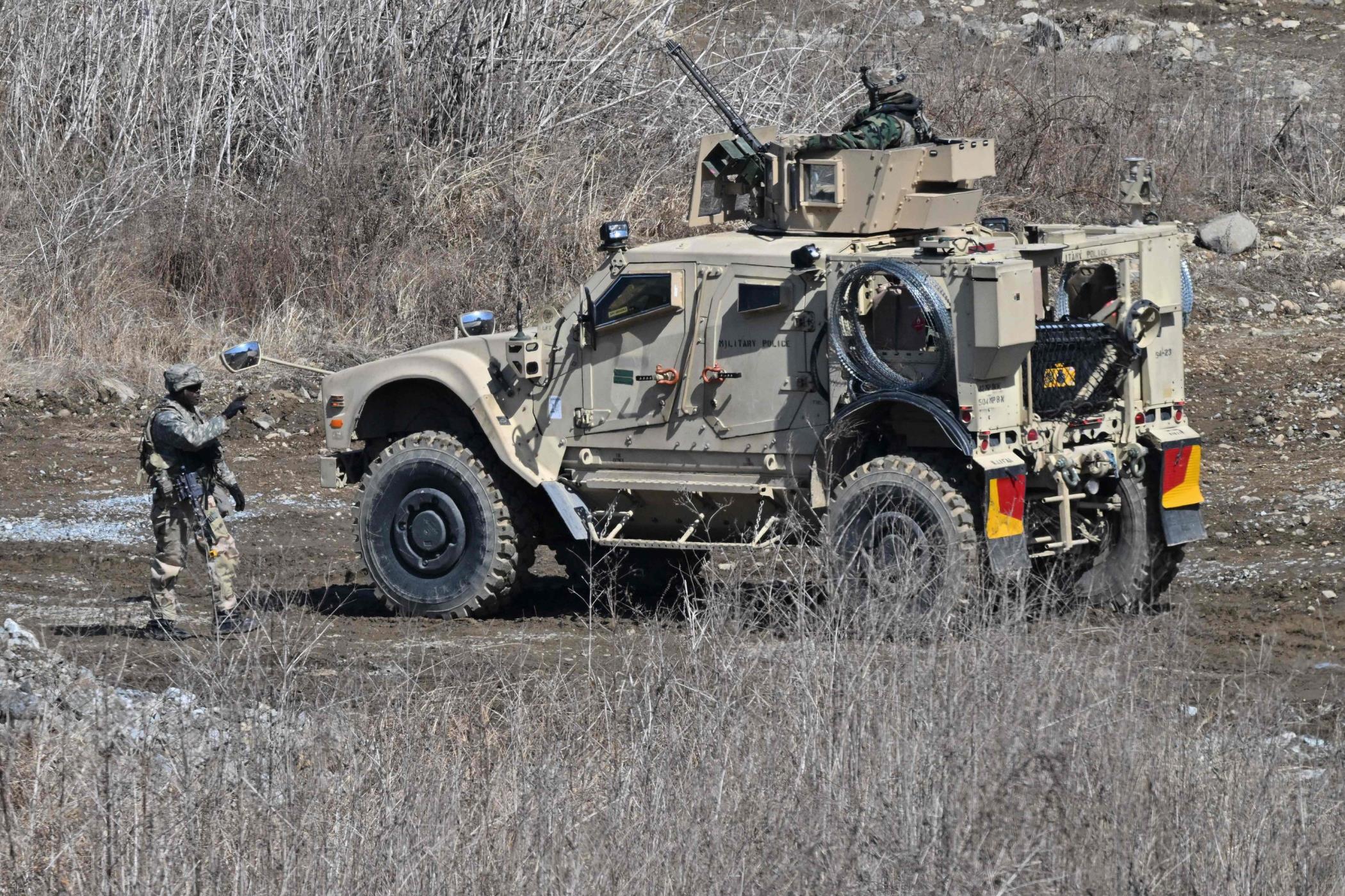 A U.S. soldier walks past a military vehicle at a military training field in the border city of Yeoncheon, South Korea, March 13, 2023. (AFP Photo)