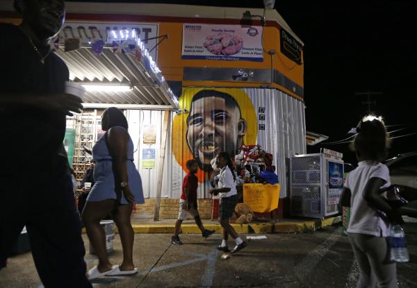 People co<em></em>ngregate in front of a mural of Alton Sterling outside the Triple S Food Mart, wher<em></em>e Sterling was killed in 2016, in Baton Rouge, L.A., U.S., May 2, 2017. (AP Photo)