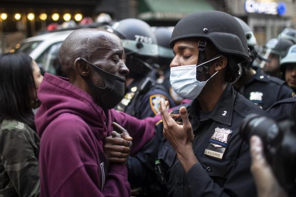 A protester and a police officer greet in the middle of a standoff in New York, U.S., June 2, 2020. (AP Photo)