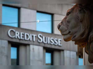 A sign of Credit Suisse bank is seen on a branch building in Geneva, on March 15, 2023. Credit Suisse shares nosedived on March 15, 2023, after its main shareholder said it would not provide more funding, with reassuring comments from the Swiss bank's chairman unable to calm the market panic. (Photo by Fabrice COFFRINI / AFP)